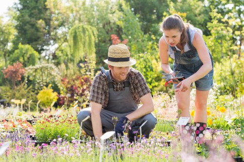 Staff member demonstrating inclusive on-site assistance during garden upkeep in Westminster